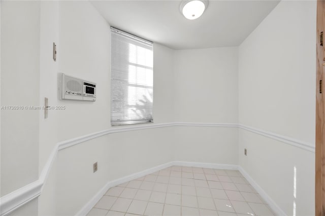 unfurnished room with baseboards