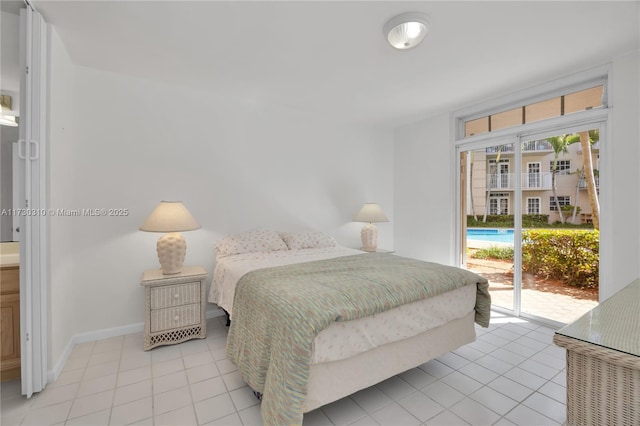 bedroom with access to outside, multiple windows, baseboards, and light tile patterned floors