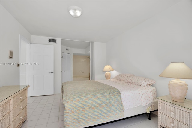 bedroom featuring light tile patterned floors and visible vents