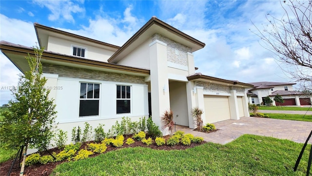 view of front facade with a garage and a front yard