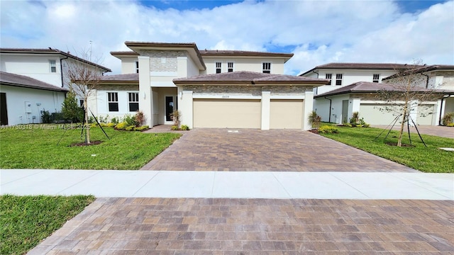 prairie-style house with a garage and a front lawn