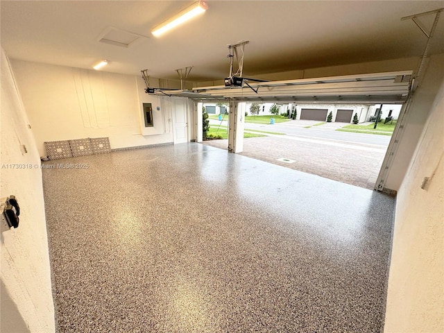 garage featuring electric panel and a garage door opener