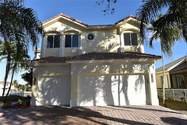 mediterranean / spanish house featuring a garage