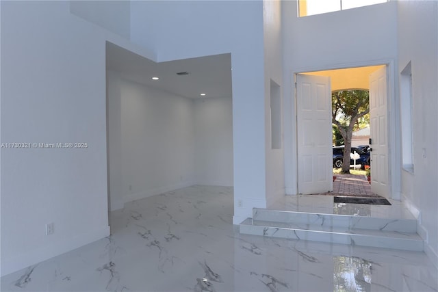 foyer with a towering ceiling