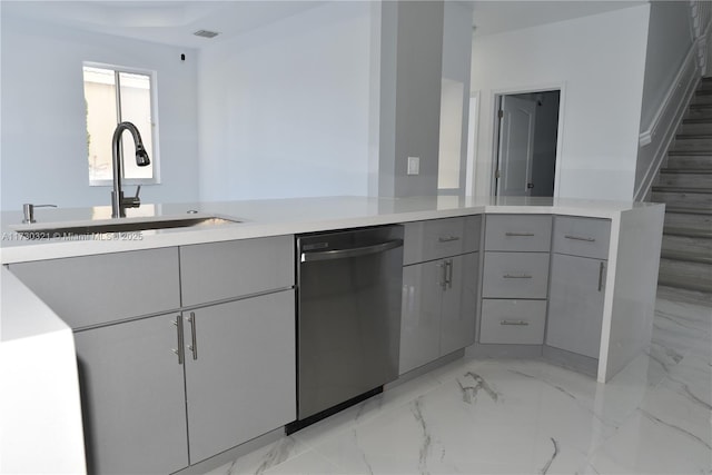 kitchen with sink, black dishwasher, gray cabinetry, and kitchen peninsula