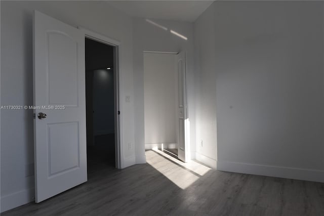 unfurnished bedroom with dark hardwood / wood-style flooring