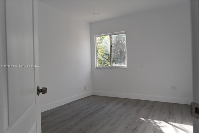 empty room with hardwood / wood-style flooring