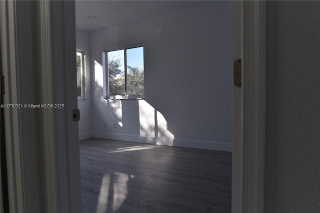 spare room with dark hardwood / wood-style floors