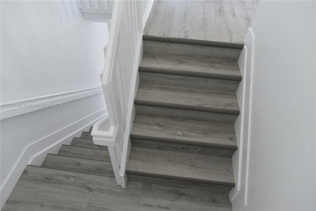 stairway featuring wood-type flooring