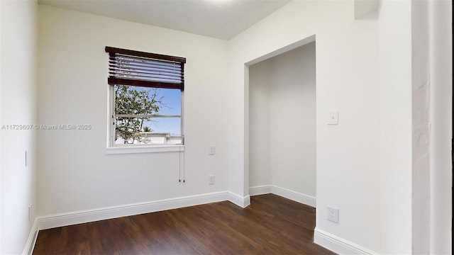 empty room featuring dark hardwood / wood-style flooring