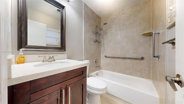 full bathroom featuring toilet, vanity, and tiled shower / bath combo