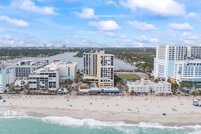 aerial view with a water view and a beach view