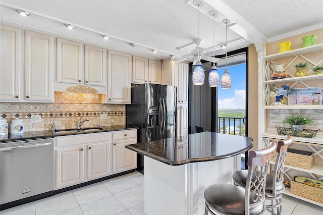 kitchen featuring pendant lighting, dishwasher, sink, light tile patterned floors, and a breakfast bar area