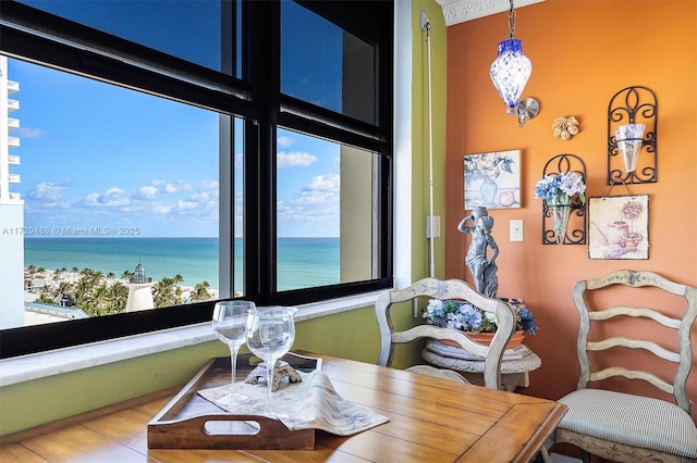 dining space featuring a water view and an inviting chandelier