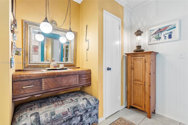 bathroom featuring vanity, ornamental molding, and tile patterned flooring