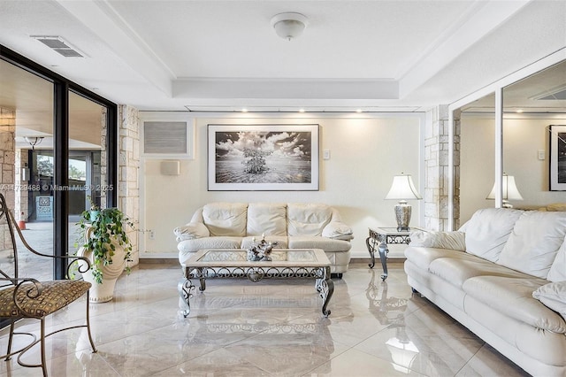 living room featuring a tray ceiling and ornamental molding