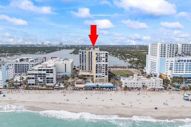 drone / aerial view with a water view and a view of the beach