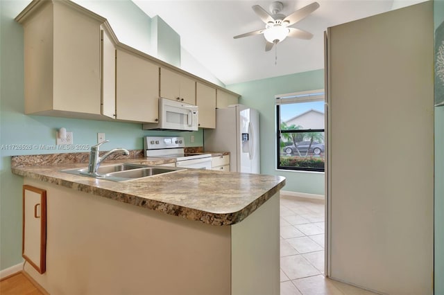 kitchen with white appliances, lofted ceiling, sink, cream cabinets, and light tile patterned floors