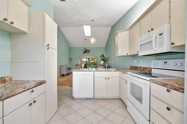 kitchen featuring white appliances, hanging light fixtures, kitchen peninsula, vaulted ceiling, and light tile patterned floors