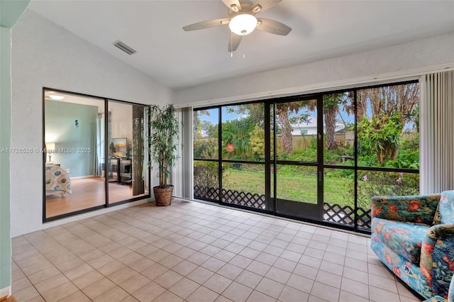 unfurnished sunroom featuring ceiling fan and lofted ceiling