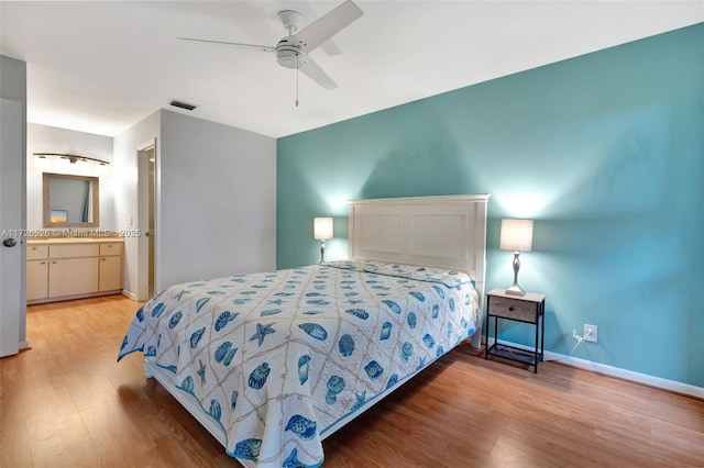 bedroom with ceiling fan, light hardwood / wood-style flooring, and ensuite bath