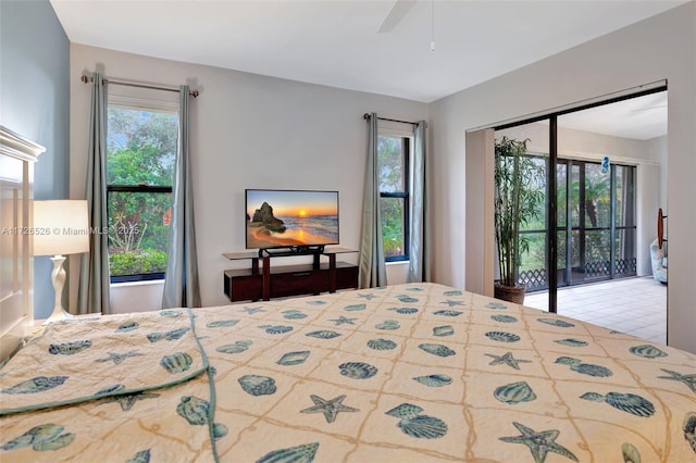 tiled bedroom featuring ceiling fan and access to outside