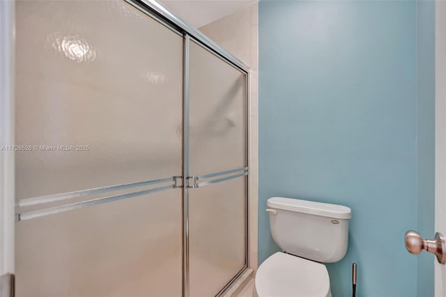 bathroom featuring toilet and walk in shower