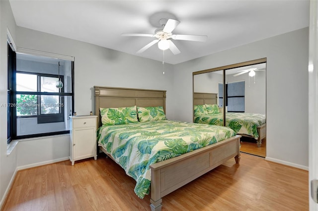 bedroom with ceiling fan, a closet, and light hardwood / wood-style flooring