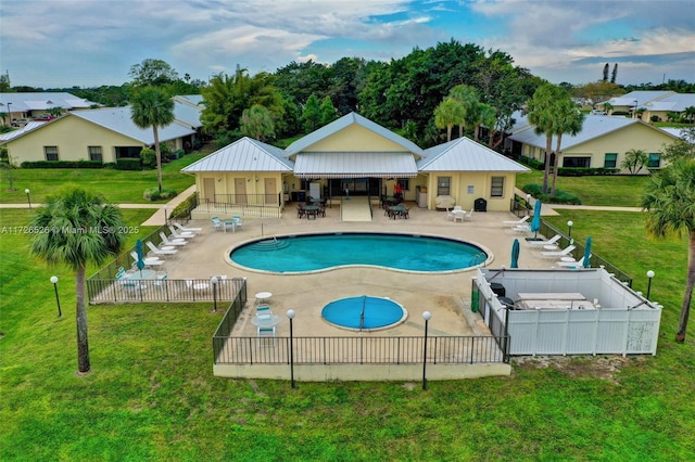 view of pool featuring a patio and a yard