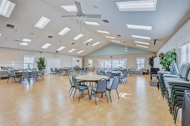 dining area featuring ceiling fan and high vaulted ceiling