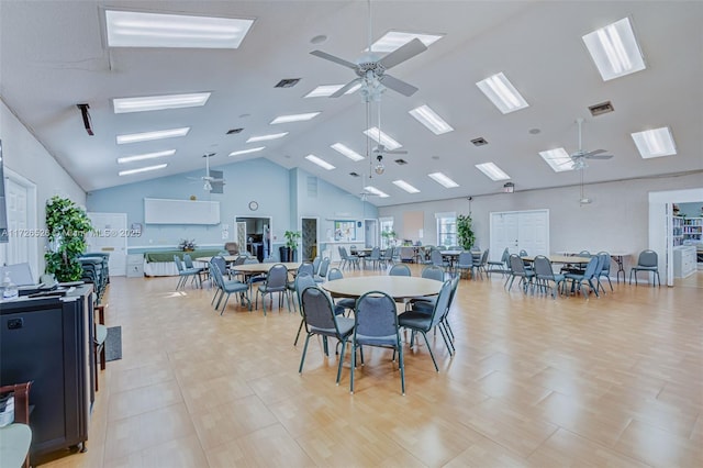 dining area with high vaulted ceiling and ceiling fan