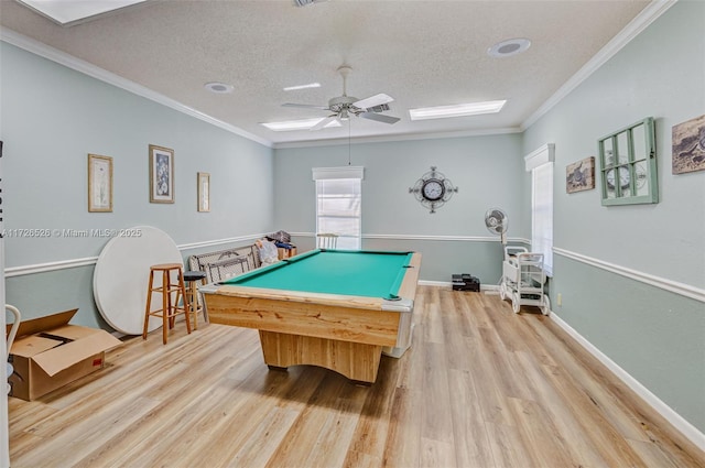 game room with a textured ceiling, billiards, light hardwood / wood-style flooring, and crown molding