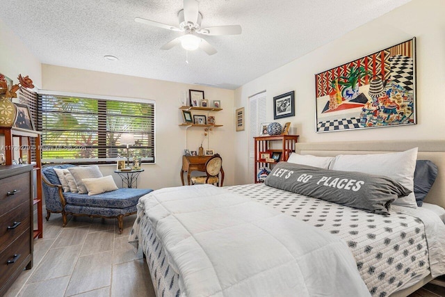 bedroom featuring a textured ceiling and ceiling fan