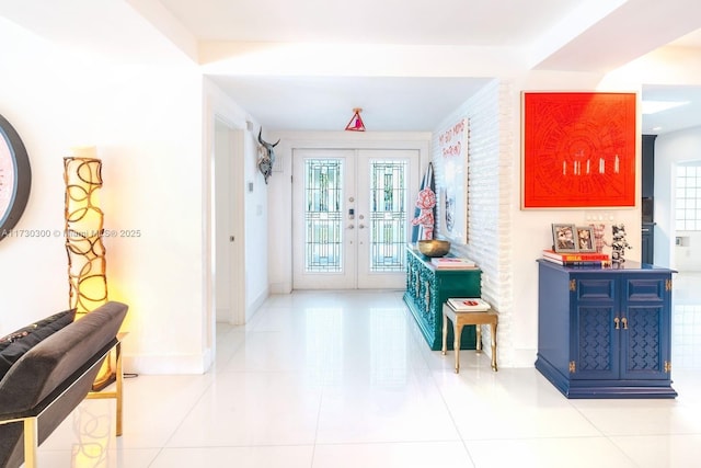 hall featuring light tile patterned flooring and french doors