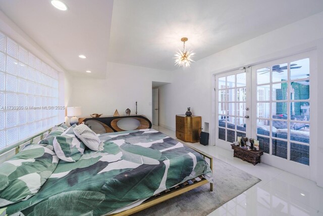 bedroom with french doors and a notable chandelier