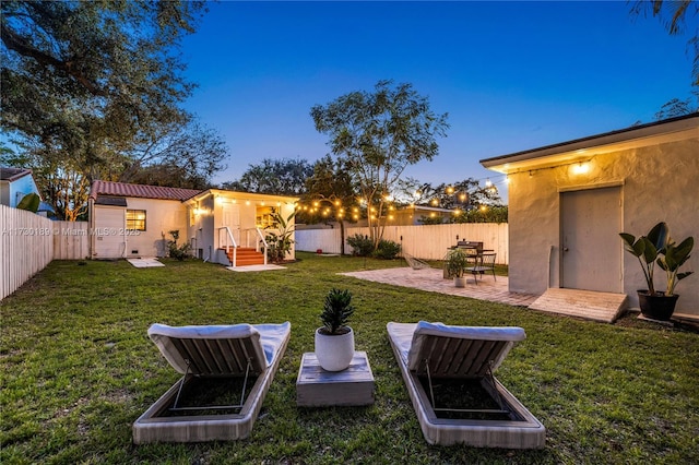 yard at dusk with a patio