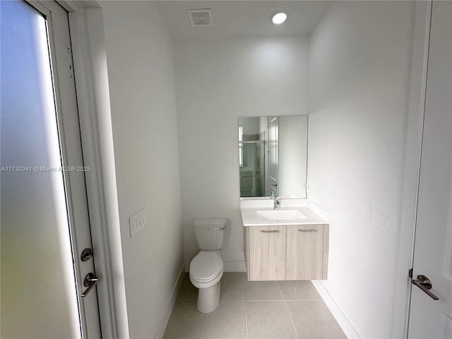 bathroom with a shower with door, toilet, tile patterned floors, and vanity