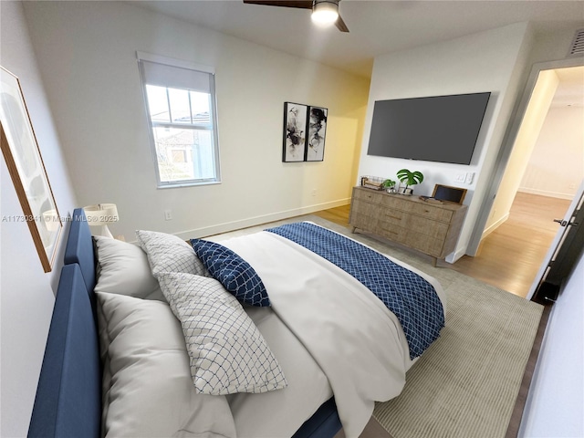 bedroom with hardwood / wood-style flooring and ceiling fan