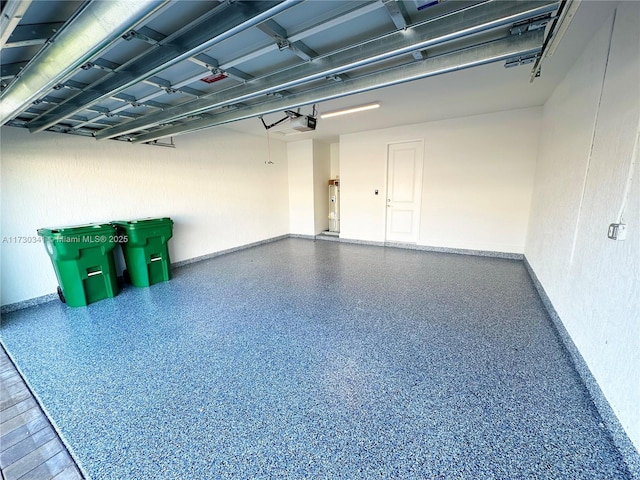 garage with electric water heater and a garage door opener