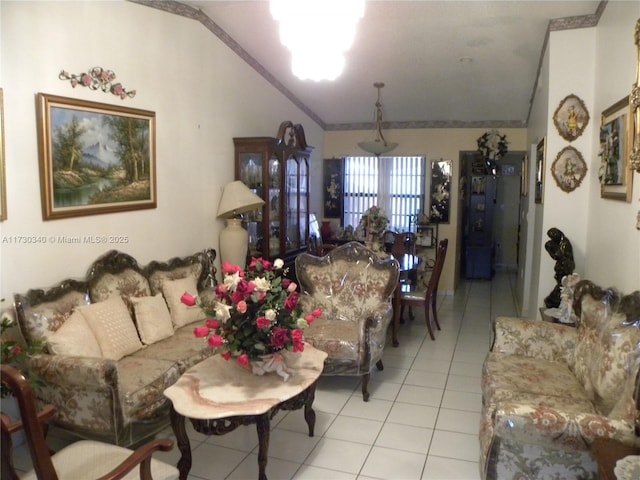 tiled living room with ornamental molding and lofted ceiling