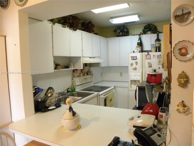 kitchen with white cabinets, white appliances, kitchen peninsula, and sink