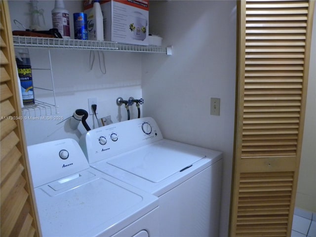 washroom with washer and clothes dryer and tile patterned floors