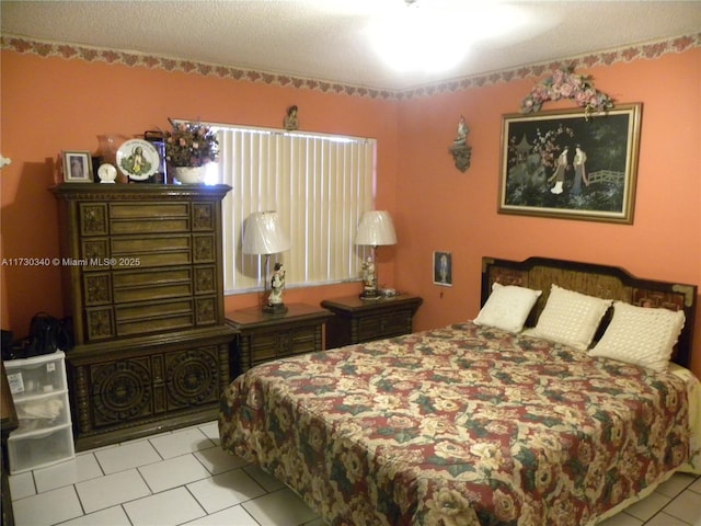 bedroom featuring a textured ceiling and light tile patterned flooring