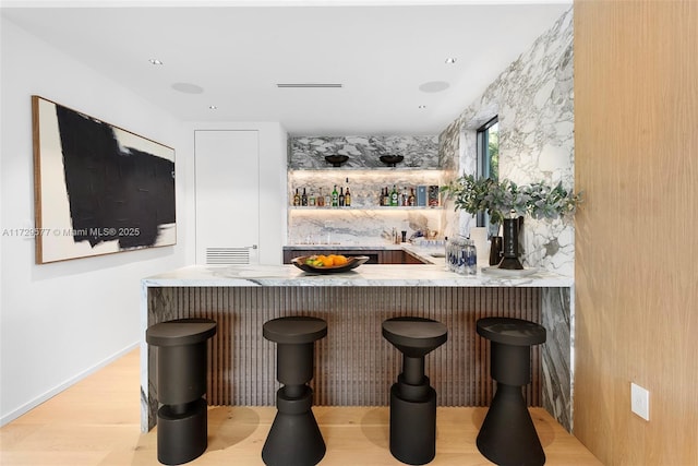 bar featuring light hardwood / wood-style flooring