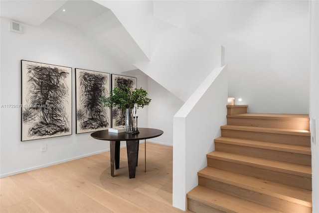 stairway with hardwood / wood-style flooring