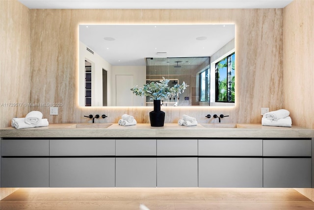 bathroom featuring walk in shower and vanity