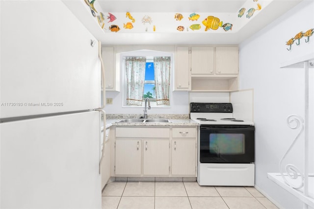 kitchen featuring sink, white cabinets, light tile patterned floors, electric range oven, and white fridge