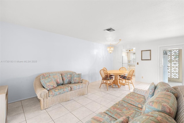 tiled living room with a chandelier