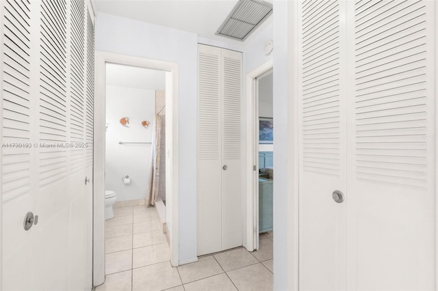 corridor featuring light tile patterned floors