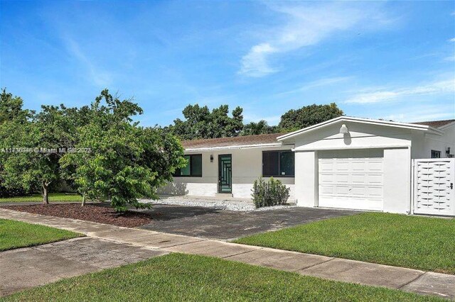 ranch-style home with a garage and a front yard